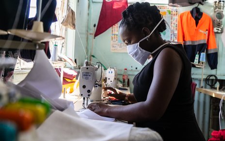 A woman working and wearing a face mask at a garment manufacturing factory in Harare, Zimbabwe during the Covid-19 pandemic in 2020